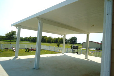 Example of a large classic backyard patio design in Other
