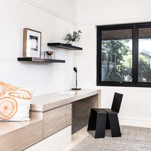 Photo of a medium sized modern study in Perth with white walls, limestone flooring and a built-in desk.