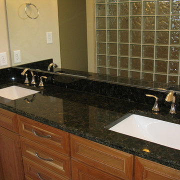 Granite countertop with glass block shower in a bathroom remodel Raleigh North C