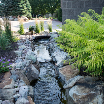 Rustic Mountain stream flowing into lakeside patio