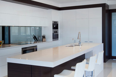 Design ideas for a modern kitchen in Perth with an undermount sink, flat-panel cabinets, white cabinets, grey splashback, with island, quartz benchtops, mirror splashback and white benchtop.