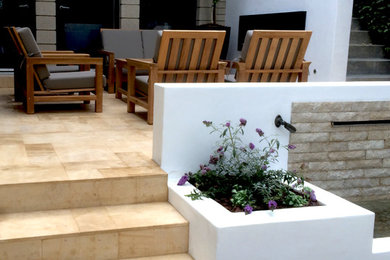 Mid-sized tuscan backyard stone patio kitchen photo in Los Angeles with no cover