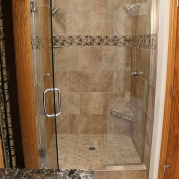 Moline, IL Bathroom Remodel Removes Jacuzzi, Adds a Bench Seat and Tiled Shower.