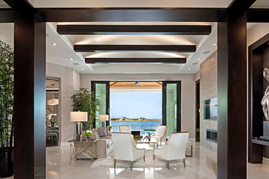 Example of a large trendy formal and enclosed marble floor and beige floor living room design in Orlando with beige walls, a ribbon fireplace, a metal fireplace and a wall-mounted tv