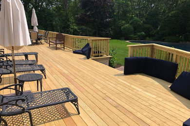 Example of a large classic wood railing deck design in New York