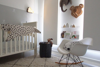 Design ideas for a mid-sized contemporary nursery in Gold Coast - Tweed with white walls and concrete floors.