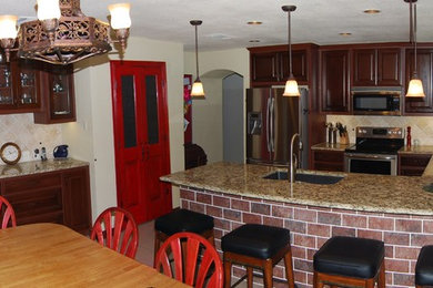 Eat-in kitchen - traditional u-shaped slate floor eat-in kitchen idea in Austin with a single-bowl sink, raised-panel cabinets, brown cabinets, laminate countertops, stone tile backsplash, white appliances and no island