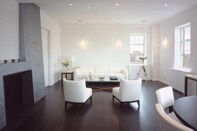 Inspiration for a contemporary living room in New York with white walls and dark hardwood floors.