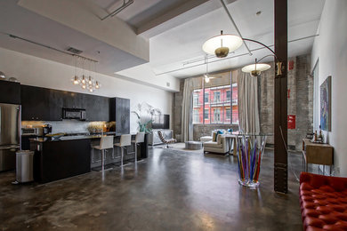 Example of a large trendy open concept concrete floor living room design in New Orleans with white walls and a tv stand
