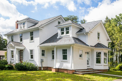 Example of a small classic white three-story mixed siding exterior home design in Philadelphia with a hip roof