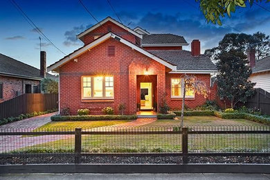 Photo of an expansive traditional three-storey brick red exterior in Melbourne.
