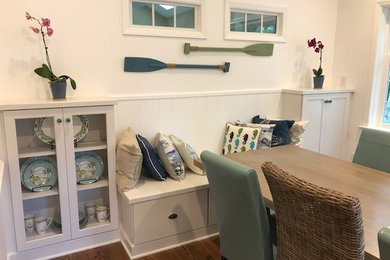 Dining room - coastal medium tone wood floor and brown floor dining room idea in Raleigh