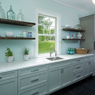 This is an example of a beach style galley kitchen pantry in Minneapolis with an undermount sink, flat-panel cabinets, grey cabinets, quartz benchtops, stainless steel appliances and dark hardwood floors.