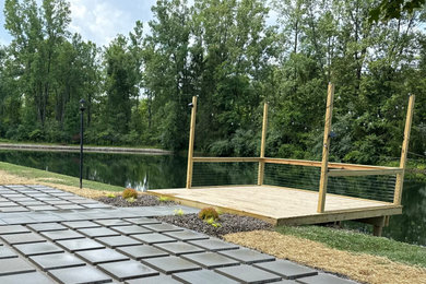 Dock - mid-sized ground level wood railing dock idea in Cleveland with no cover