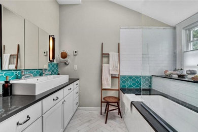 Bathroom - mid-sized transitional master multicolored tile and ceramic tile marble floor, gray floor, double-sink and vaulted ceiling bathroom idea in New York with shaker cabinets, white cabinets, an undermount tub, a vessel sink, quartz countertops, a hinged shower door, brown countertops and a built-in vanity