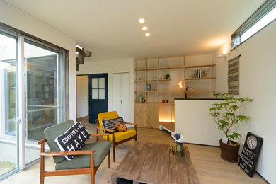 This is an example of a country living room in Osaka with white walls and painted wood floors.