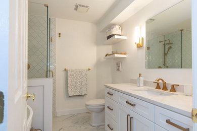 Bathroom - small traditional white tile and ceramic tile ceramic tile, white floor and single-sink bathroom idea in Vancouver with shaker cabinets, white cabinets, a two-piece toilet, white walls, an undermount sink, quartz countertops, a hinged shower door, white countertops and a built-in vanity