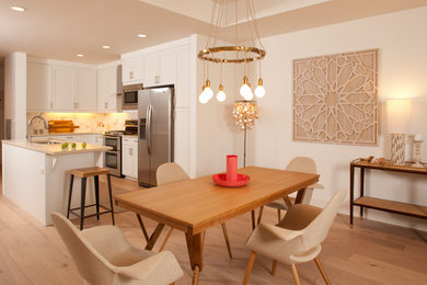 Transitional light wood floor and beige floor kitchen/dining room combo photo in Denver with white walls