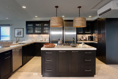 Large island style u-shaped porcelain tile and beige floor kitchen photo in San Diego with a double-bowl sink, shaker cabinets, black cabinets, quartz countertops, stainless steel appliances, an island and beige countertops