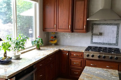 Mid-sized trendy u-shaped limestone floor eat-in kitchen photo in Sacramento with a farmhouse sink, raised-panel cabinets, dark wood cabinets, granite countertops, white backsplash, porcelain backsplash, stainless steel appliances and an island