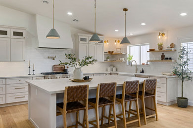 Example of a large transitional u-shaped eat-in kitchen design in Phoenix with shaker cabinets, gray cabinets, white backsplash, stainless steel appliances and an island
