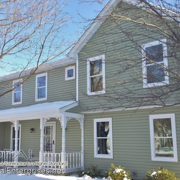 Front Porch with White Fretwork & Green Vinyl Siding