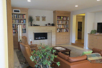 Mid-sized elegant open concept living room library photo in Orange County with white walls, a standard fireplace, a tile fireplace and no tv