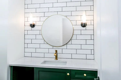 Inspiration for a small contemporary white tile and ceramic tile ceramic tile and black floor powder room remodel in St Louis with recessed-panel cabinets, green cabinets, a two-piece toilet, white walls, an undermount sink, quartz countertops, white countertops and a built-in vanity