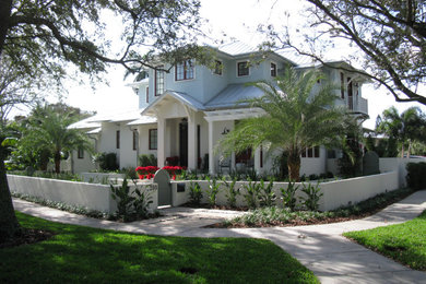 Large beach style blue two-story concrete fiberboard house exterior photo in Tampa with a hip roof and a metal roof