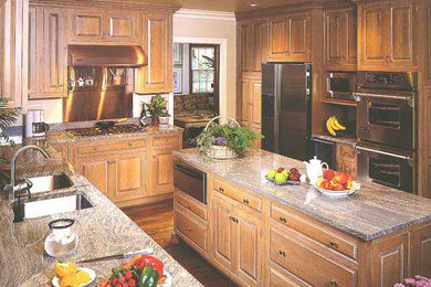 Example of a kitchen design in Edmonton with light wood cabinets
