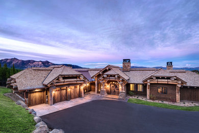 Large rustic brown wood house exterior idea in Other