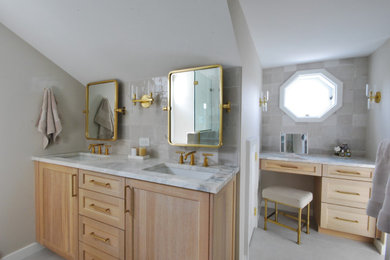 Example of a large transitional master beige tile and porcelain tile porcelain tile, beige floor and double-sink bathroom design in Philadelphia with shaker cabinets, light wood cabinets, a two-piece toilet, beige walls, an undermount sink, quartzite countertops, a hinged shower door, beige countertops and a built-in vanity