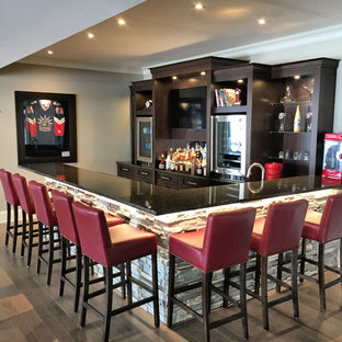 Photo of a medium sized classic fully buried basement in Ottawa with grey walls, brown floors and dark hardwood flooring.