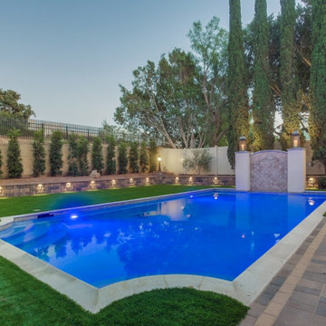Backyard Remodel with Pavers, Fireplace, Artificial Grass, Walls, Lighting