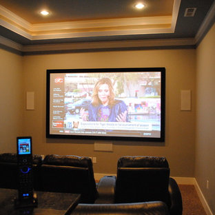 Mid-sized elegant enclosed carpeted home theater photo in Birmingham with beige walls and a wall-mounted tv