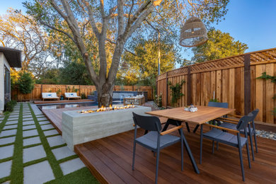 Inspiration for a mid-sized modern backyard patio remodel in San Francisco with a fire pit and decking