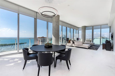 Example of a large trendy open concept marble floor and white floor family room design in Miami with gray walls and a wall-mounted tv