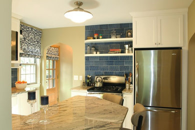 Example of a mid-sized classic u-shaped enclosed kitchen design in Minneapolis with shaker cabinets, white cabinets, blue backsplash, stainless steel appliances, a peninsula, granite countertops and subway tile backsplash