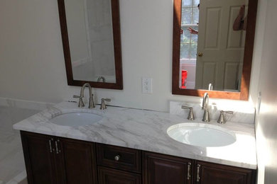 Bathroom - mid-sized master bathroom idea in DC Metro with a drop-in sink, dark wood cabinets, marble countertops and white walls