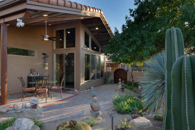 Small and desert look backyard partial sun xeriscape in Phoenix with concrete pavers.