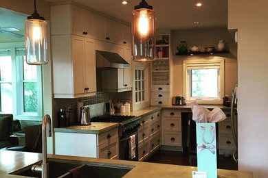 Mid-sized elegant u-shaped eat-in kitchen photo in Other with a double-bowl sink, shaker cabinets, white cabinets, concrete countertops and an island