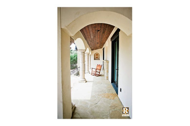 This is an example of a rustic courtyard patio in Austin with natural stone paving and a roof extension.