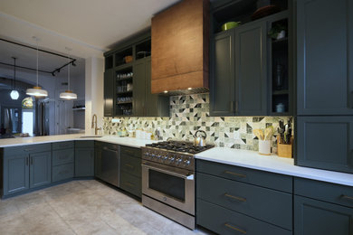 Eat-in kitchen - mid-sized eclectic u-shaped vinyl floor and gray floor eat-in kitchen idea in Baltimore with an undermount sink, recessed-panel cabinets, green cabinets, quartz countertops, green backsplash, ceramic backsplash, stainless steel appliances, a peninsula and white countertops