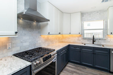 Eat-in kitchen - mid-sized cottage u-shaped vinyl floor and brown floor eat-in kitchen idea in Houston with an undermount sink, shaker cabinets, black cabinets, granite countertops, white backsplash, marble backsplash, stainless steel appliances and gray countertops