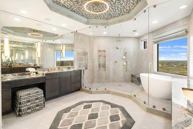 Large trendy master beige tile and porcelain tile porcelain tile, beige floor, double-sink, tray ceiling and wallpaper bathroom photo in Miami with recessed-panel cabinets, dark wood cabinets, a two-piece toilet, beige walls, an undermount sink, quartzite countertops and a built-in vanity