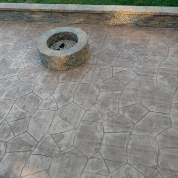 Stamped concrete patio with block seating wall and block fire-pit