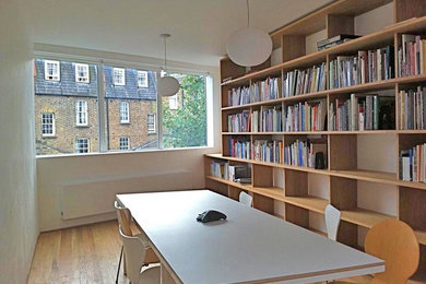 Design ideas for a mid-sized contemporary study room in London with white walls, dark hardwood floors and a freestanding desk.