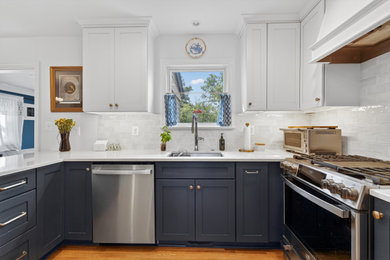 Eat-in kitchen - mid-sized transitional u-shaped medium tone wood floor and brown floor eat-in kitchen idea in DC Metro with an undermount sink, recessed-panel cabinets, blue cabinets, quartz countertops, white backsplash, subway tile backsplash, stainless steel appliances, no island and white countertops