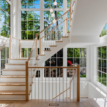 Project #152 | Three-Story White Oak Staircase with a Pendant Chandelier