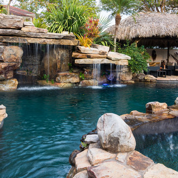 Custom Rock Waterfall Pool with Stone Grotto, Stream and Tiki Hut